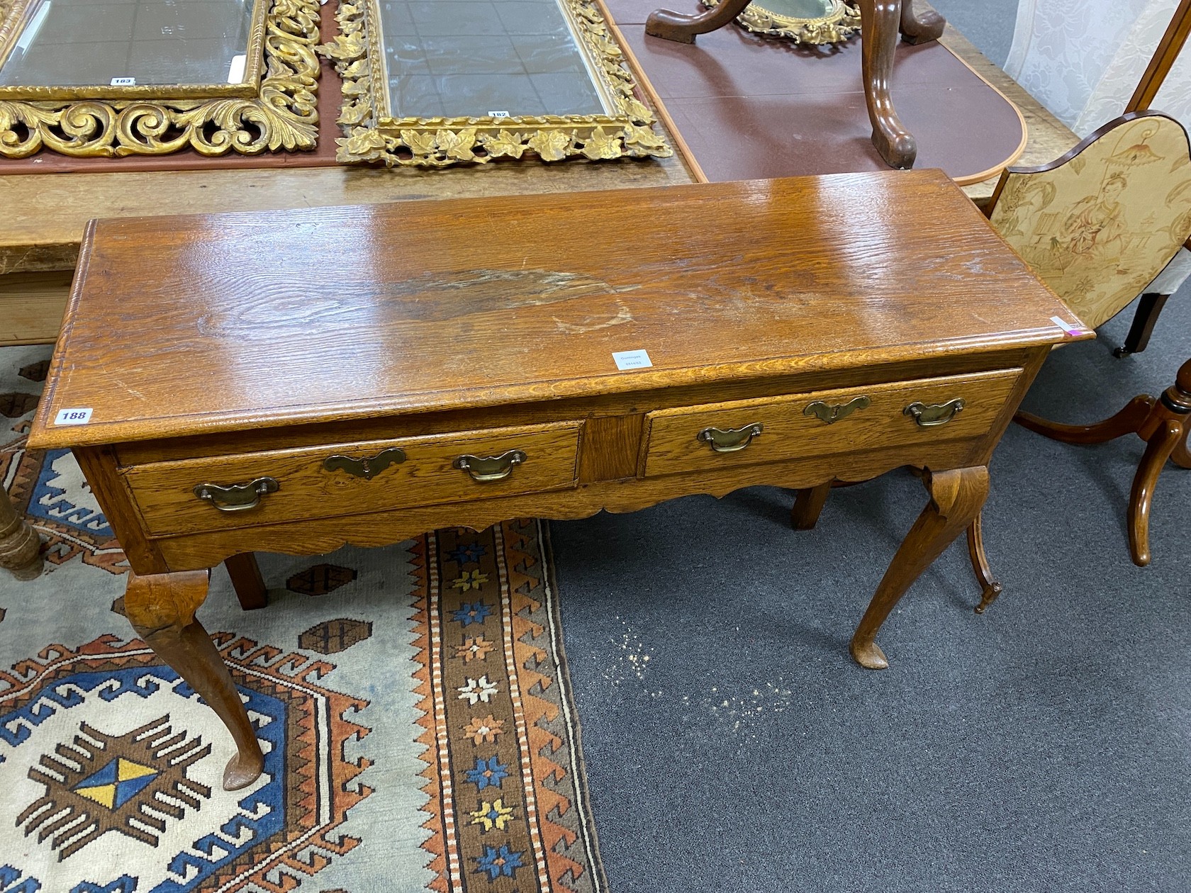 A mid 18th century style two drawer oak dresser base, width 121cm, depth 39cm, height 83cm
